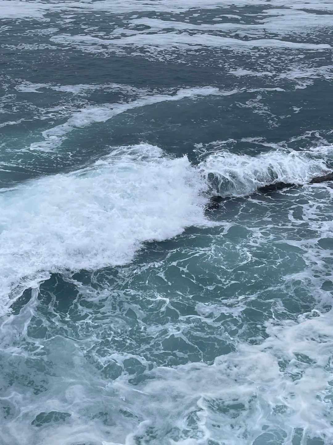 waves crashing on rocky shore phone wallpaper aesthetic