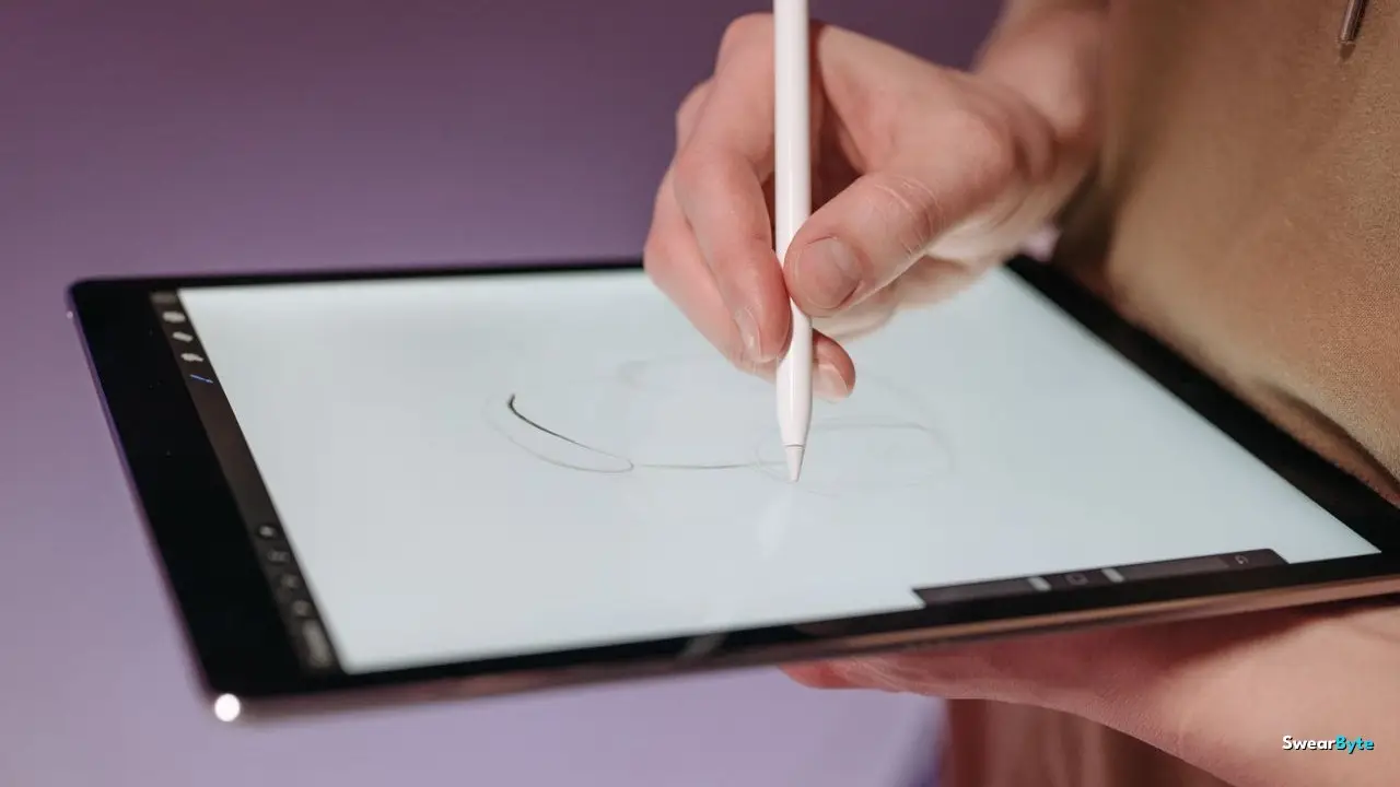 Hand sketching digital art on a tablet with a stylus